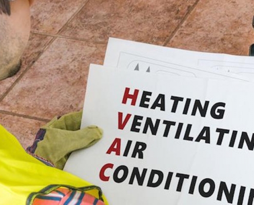 Image of a man holding a HVAC sign