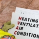 Image of a man holding a HVAC sign