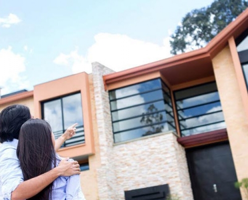 Image of a couple outside a new house