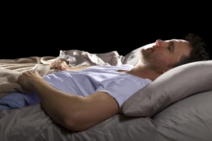 Image of a man can't sleep in bed