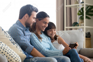 Image of Family with kid daughter smiling looking at smartphone making vi