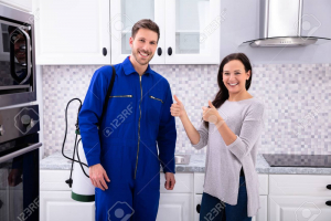 Image of Smiling Woman Showing Thumbs Up Sign With Pest Control Worker