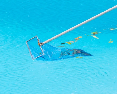 Images of leaves in a swimming pool being cleaned