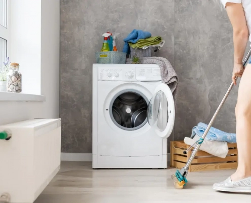 Woman mopping floor of laundry room