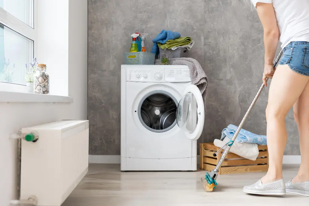 Woman mopping floor of laundry room