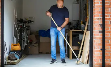 A man cleaning the garage