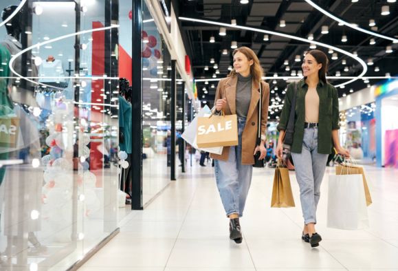 2 women going shopping in a mall